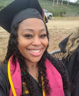 A selfie of Jasmin Smith in a graduation gown.