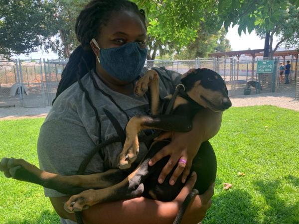 A photo of Breanna Lopez with a doggy. 