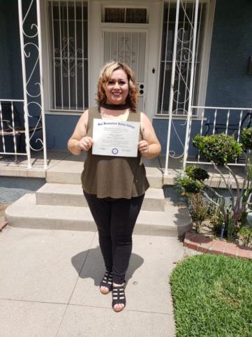 Eloisa Contreras standing with her AA-T Degree