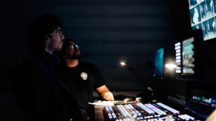 two students working in the KVCR control room. 