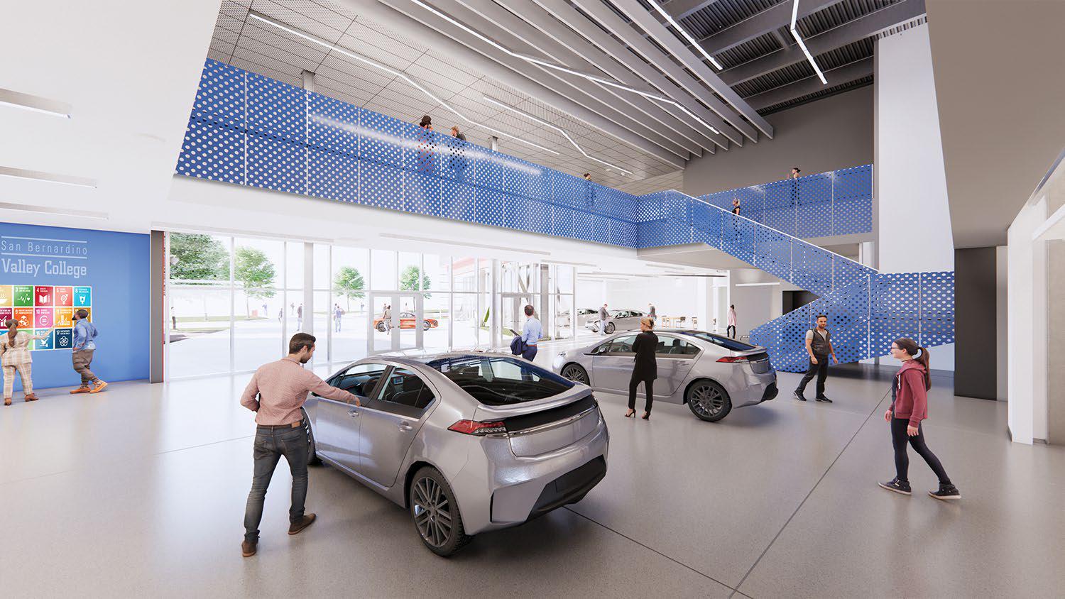 Inside the Applied Technology Building with electric vehicles parked on the first floor and students walking around and on the second floor