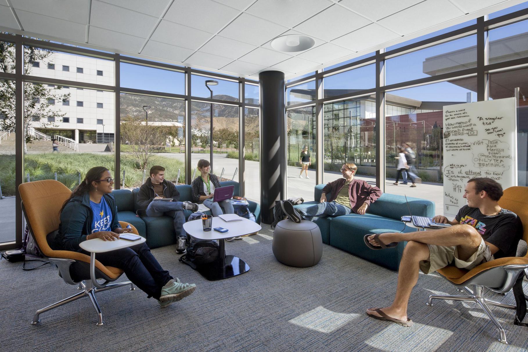 CSUSB students sitting together laughing in a dorm