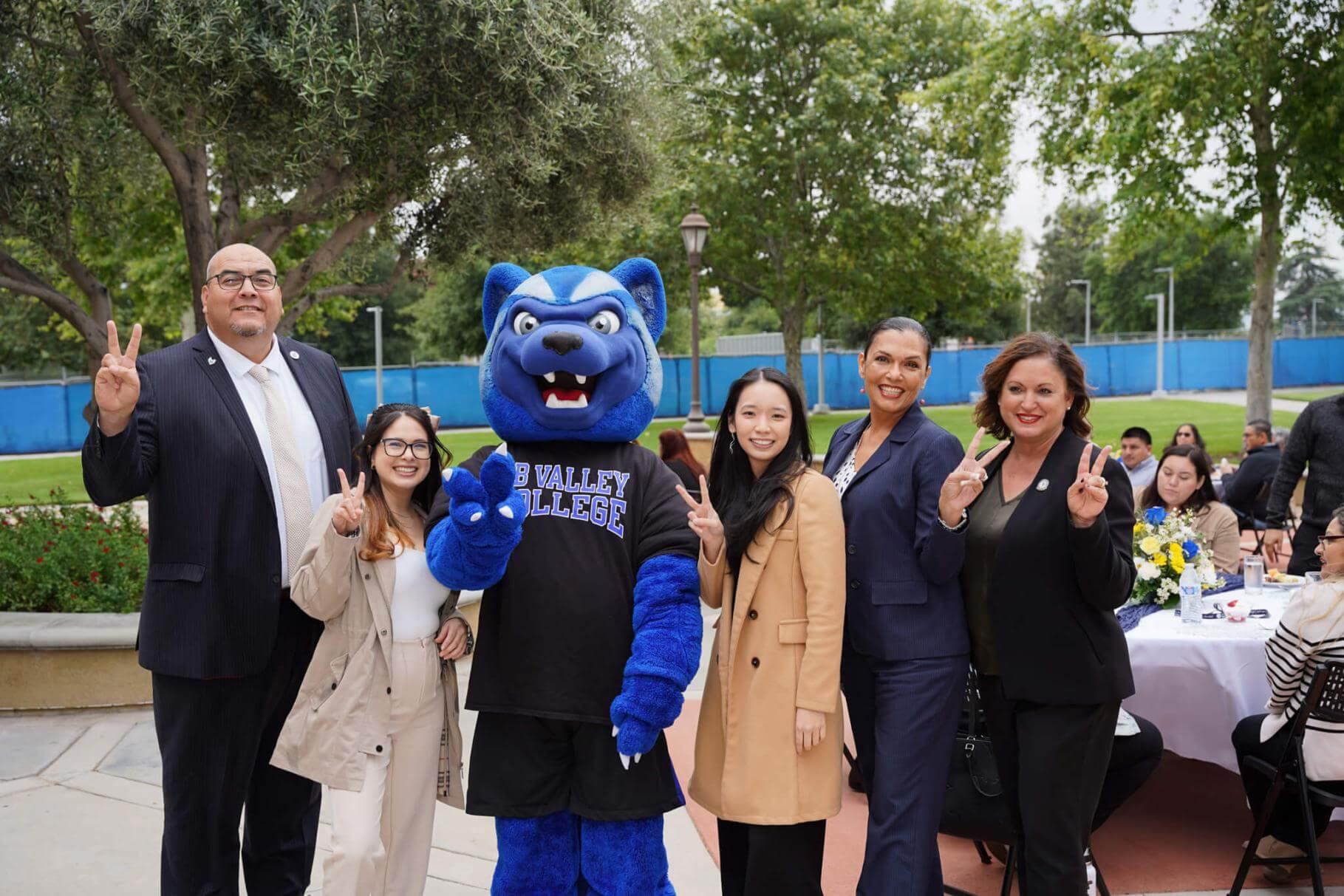 President Contreras with administrators flashing the "Valley Up" symbol