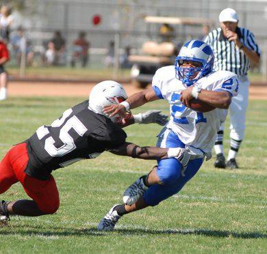 football player avoiding tackle